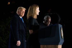 President Donald J. Trump and Supreme Court Associate Justice Clarence Thomas listen as Justice Amy Coney Barrett delivers remarks