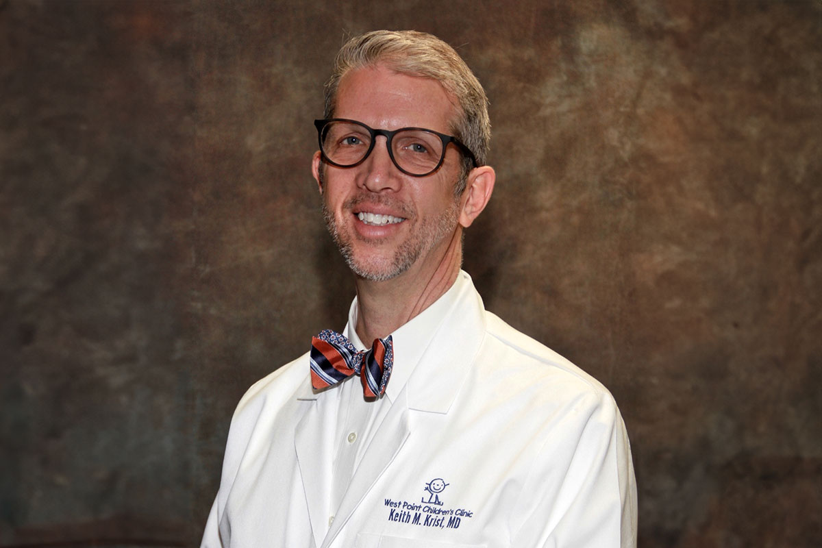 Dr. Keith Krist in his doctor's coat for West Point Children's Clinic