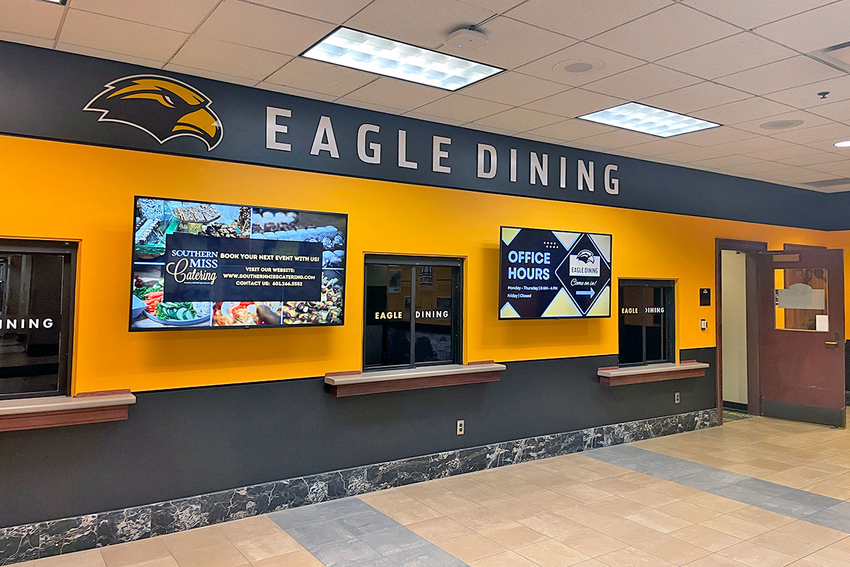 The inside of Eagle Dining, with the school's black and gold colors on the walls