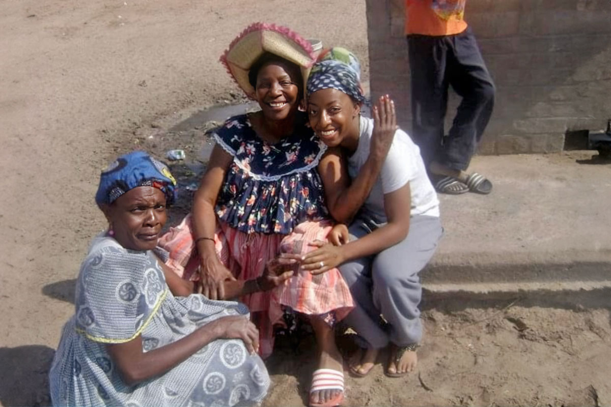 Shanina Carmichael with two other women, standing outside of a building n Nambia