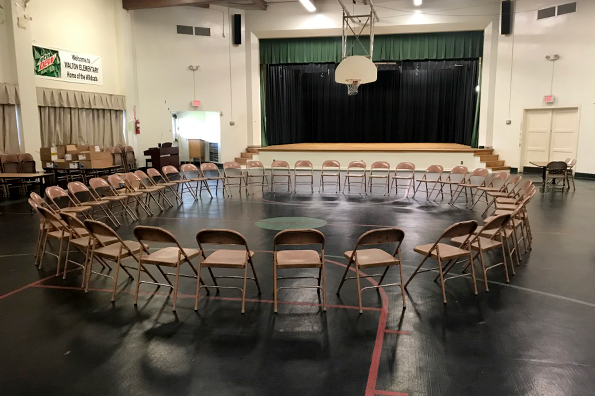A circle of chairs in a gym