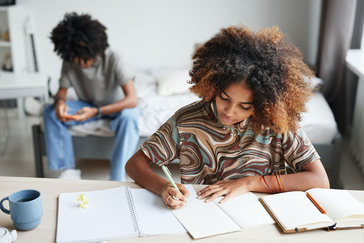 Student concentrating on classwork in a dorm room