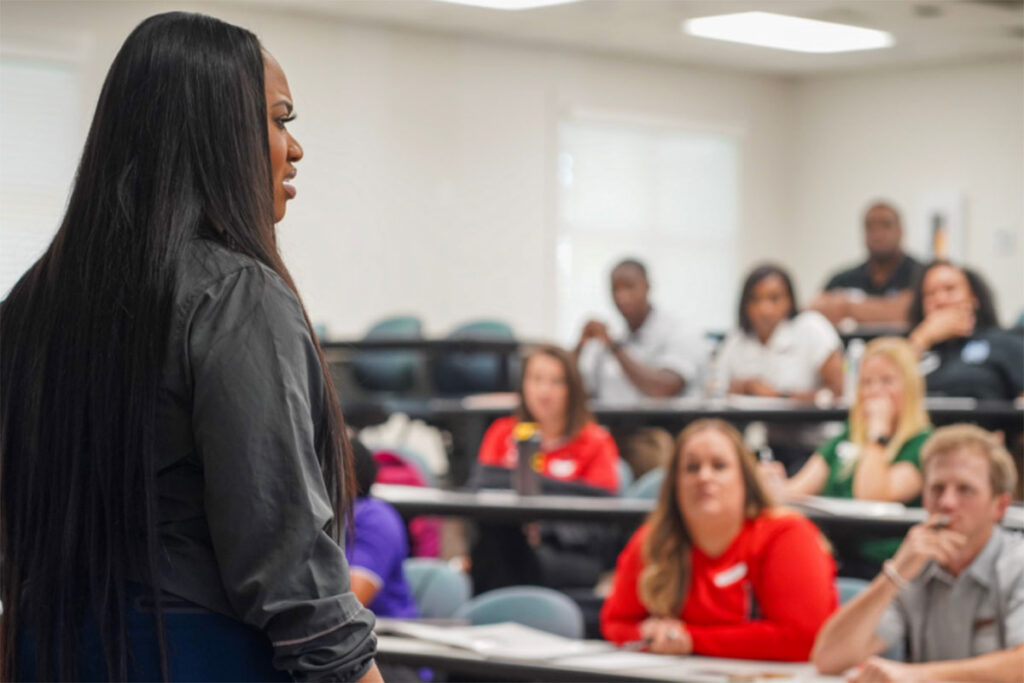 Jackson State University Women’s Basketball Coach Tomeika Reed speaking to a classroom of people