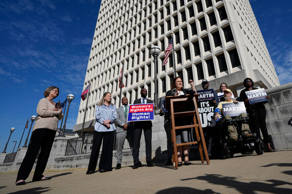 Greta Kemp Martin speaks at a press conference in front of the Walter Stillers State Office building