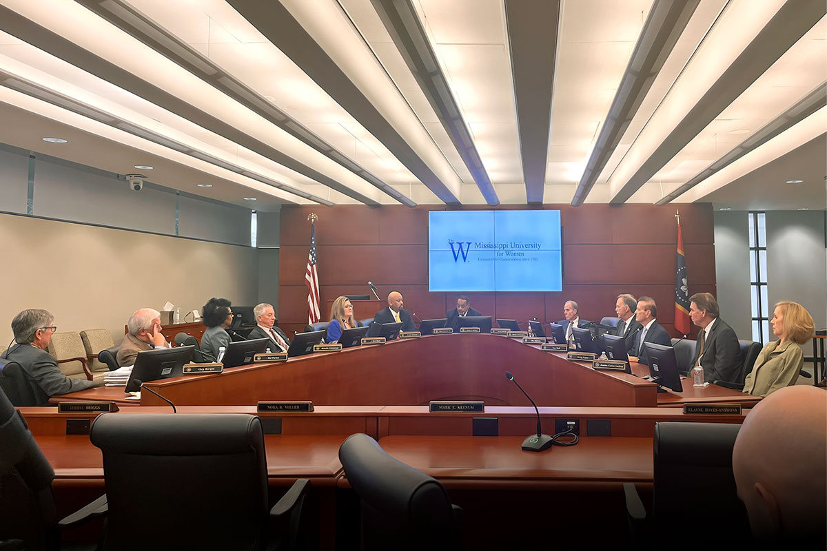 The IHL board discussing at a triangular table