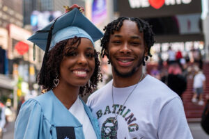 Joshua Brown with his sister in graduate robes