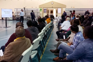 Several people seated for a community meeting