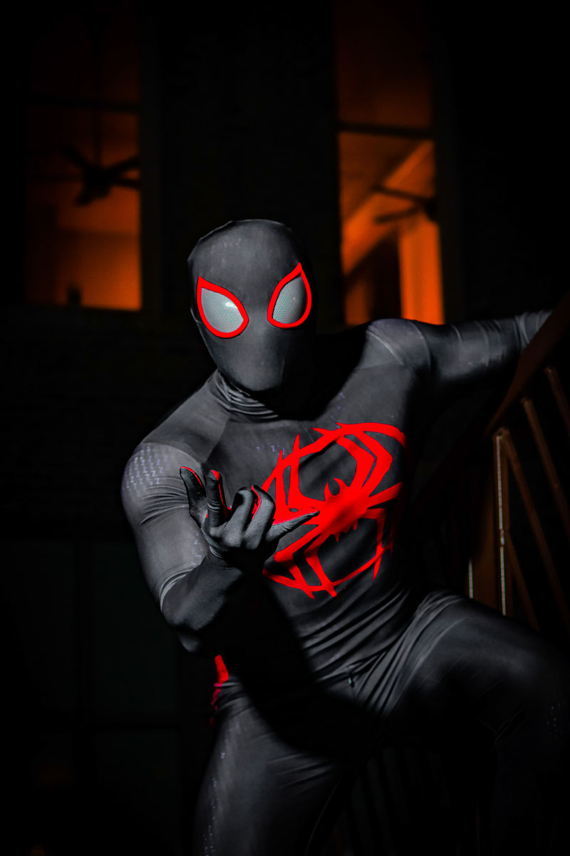 Preston Wallace dressed in a black Spiderman costume with a red spider logo on the chest