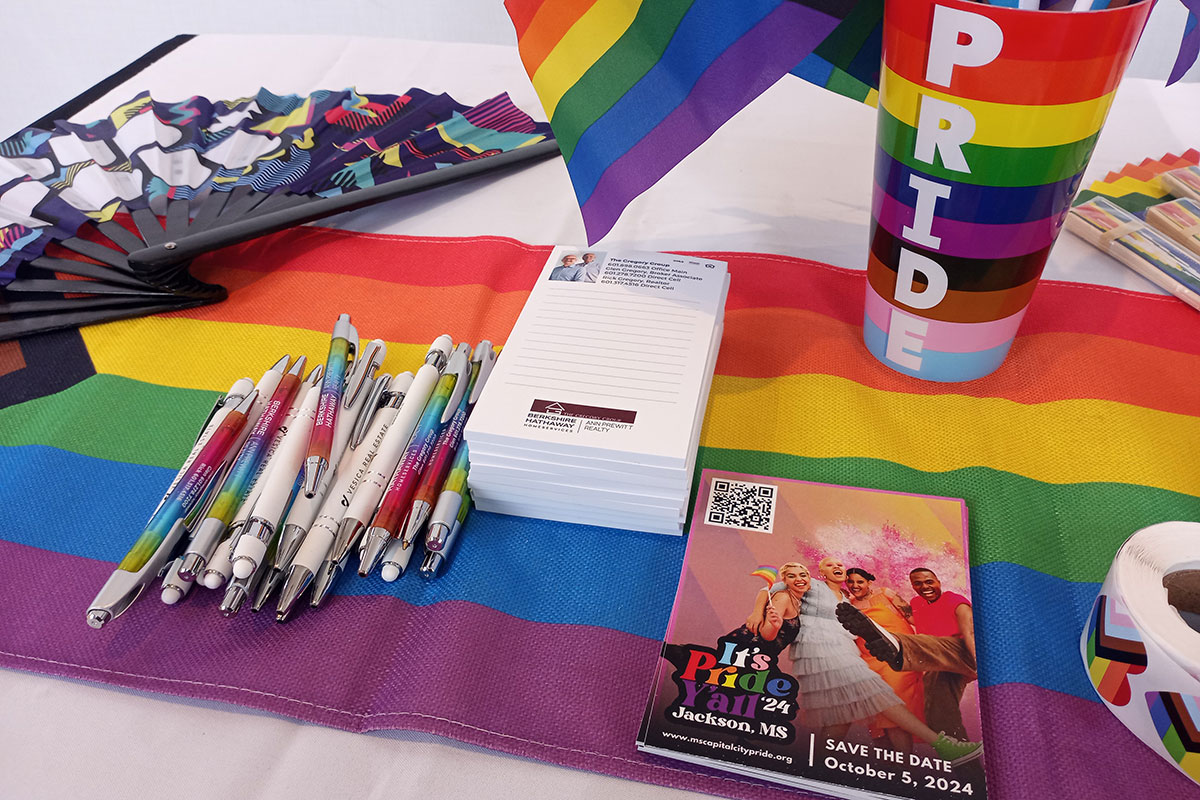 A table full of pride themed swag at the Jackson Black Pride health symposium