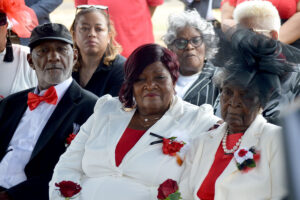 Wade family seated outside at the funeral