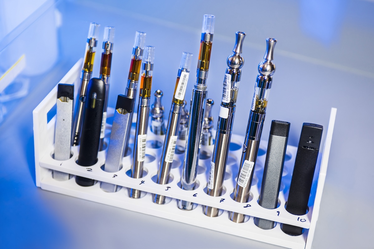 various e-cigarettes or vapes in a test tube rack
