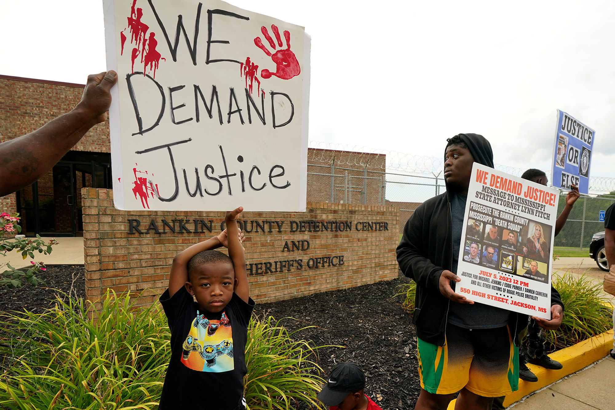 An anti-police brutality activist looks back at the entrance to the Rankin County Sheriff's Office in Brandon, Miss