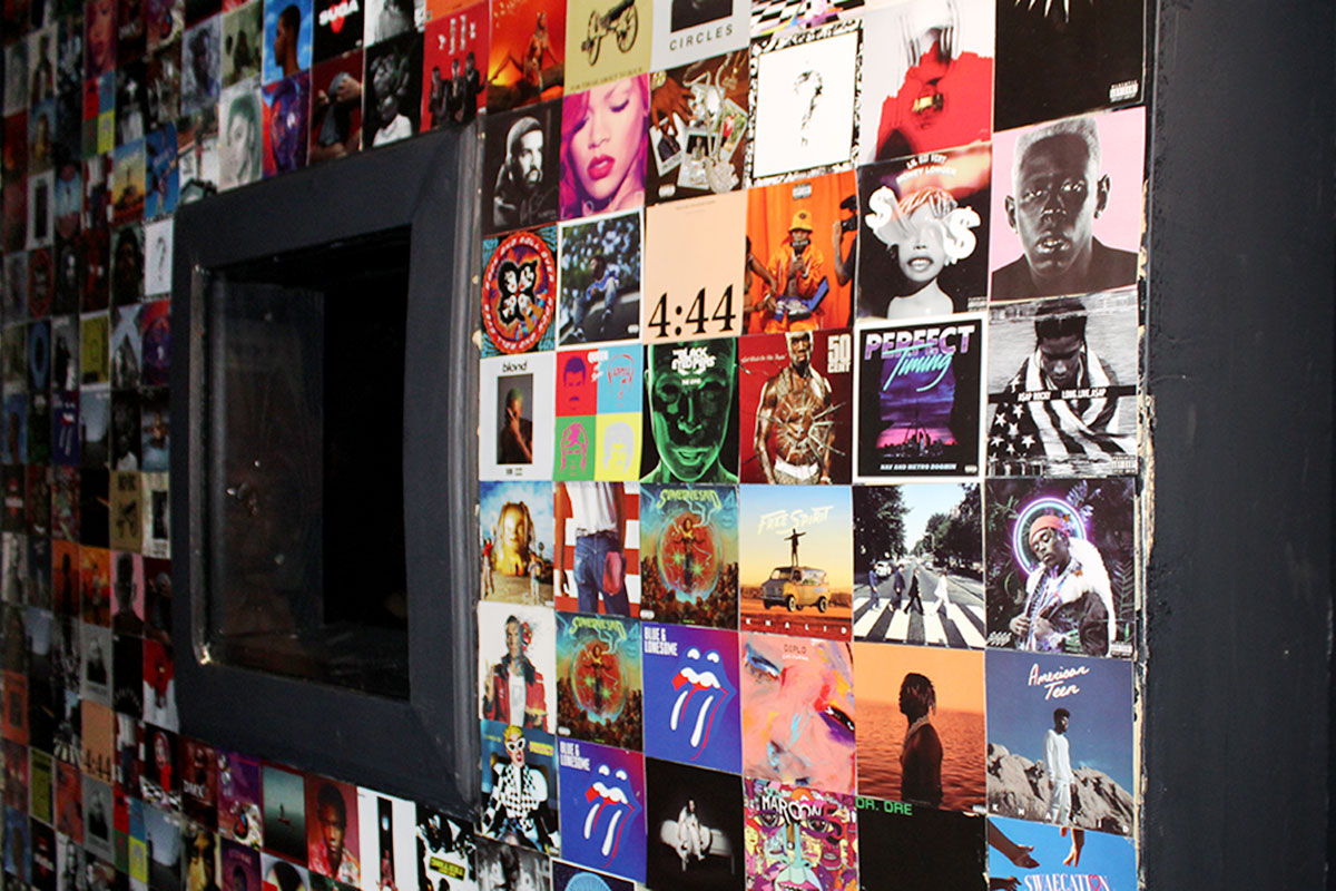 A wall covered in album cover artwork