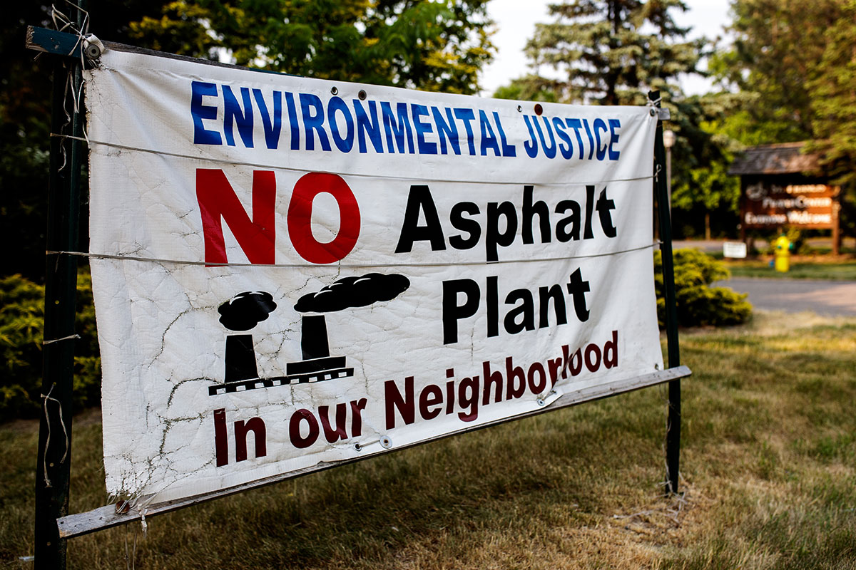 A sign that reads: Environmental Justice. No Asphalt Plant in our Neighborhood