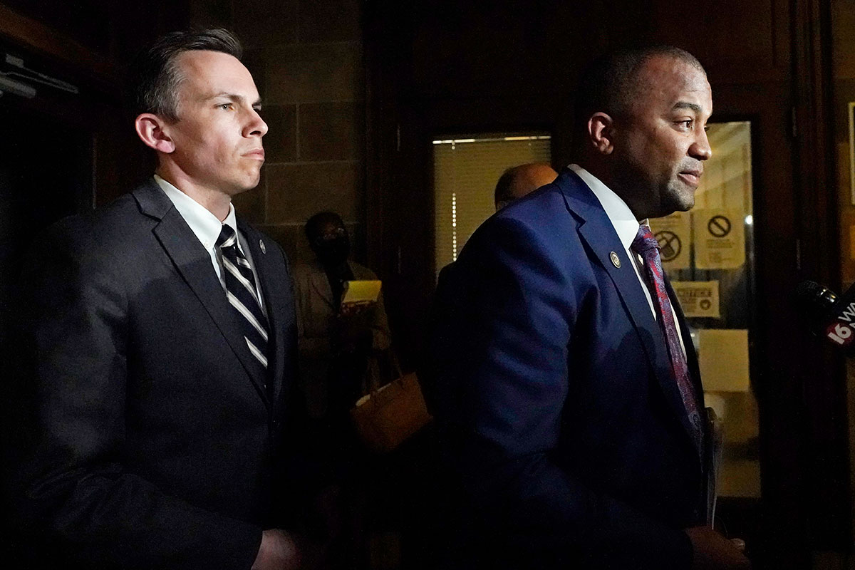Mississippi State Auditor Shad White, left, listens to Hinds County District Attorney Jody Owens answer reporters questions