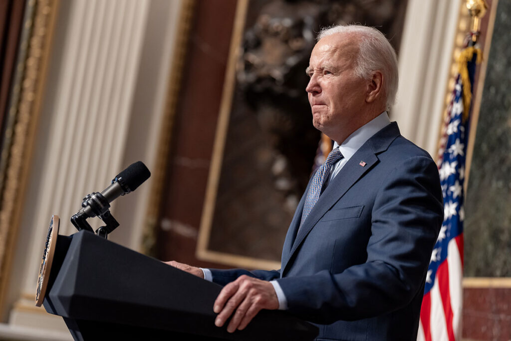 President Joe Biden addresses a group from the podium