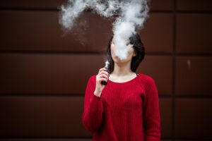 A person's vape cloud obscures their face