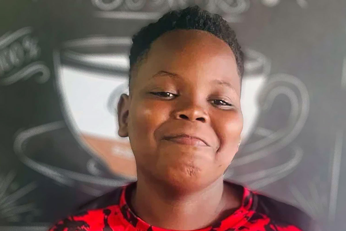 Quantavious Eason smiling in front of an illustration of a coffee cup