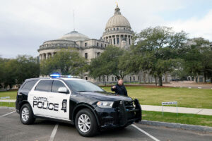 A view of the Mississippi State Capitol building with a Capitol Police car parked in front