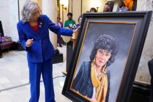 Alyce Clarke inspects her official portrait in the Mississippi State Capitol