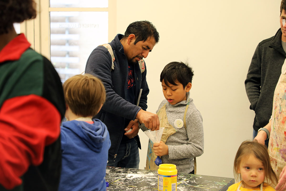 Parents and children work together on crafts