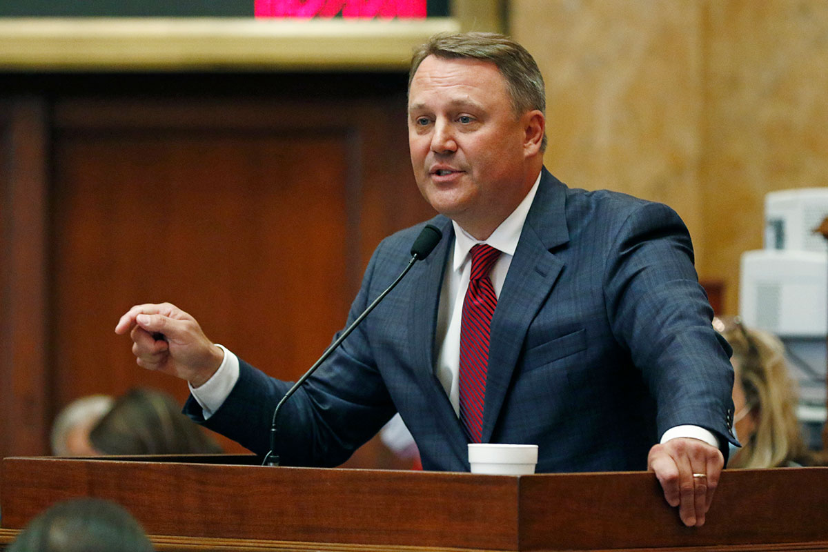 Jason White speaks from the podium at the Mississippi Capitol.