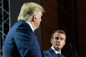 President Donald J. Trump and French President Emmanuel Macron face each other on a stage