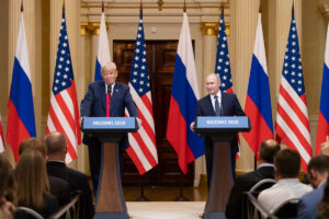 President Donald J. Trump and President Vladimir Putin speak from matching podiums labeled "Helsinki 2018." Behind them are a line of US and Russian flags.