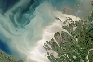 A satellite view of a river basin and how it feeds into the land
