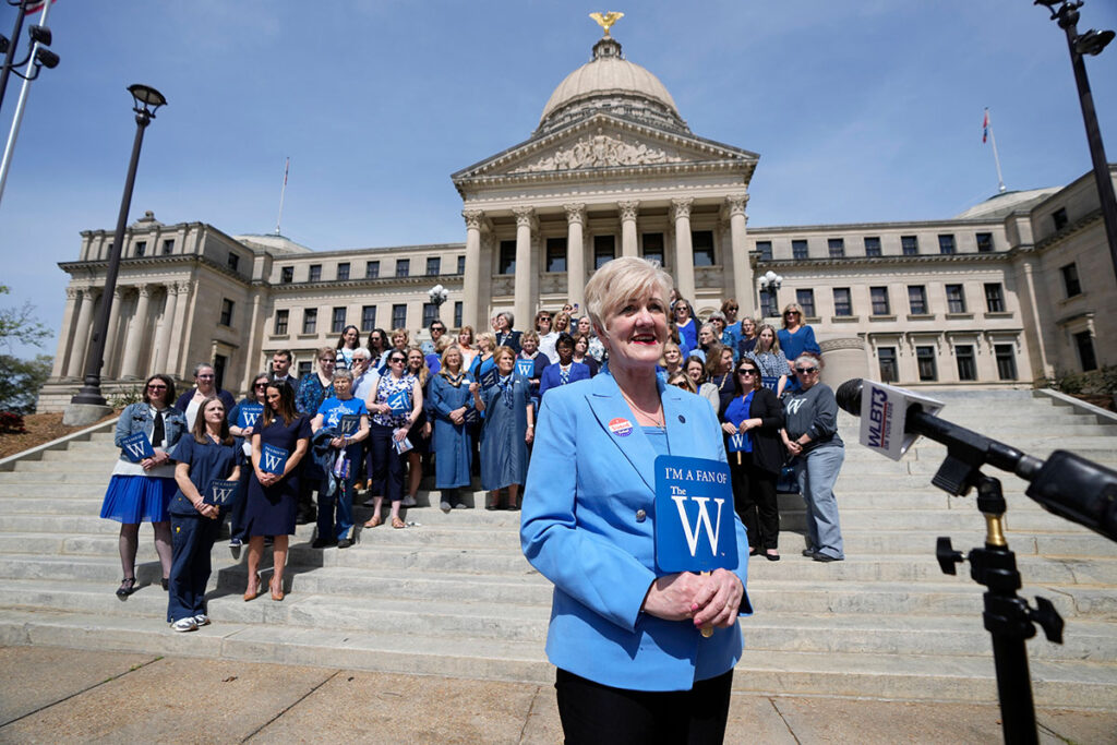 Mississippi University for Women President Nora Miller, center, stands with alumni on the steps of the Mississippi State Capitol