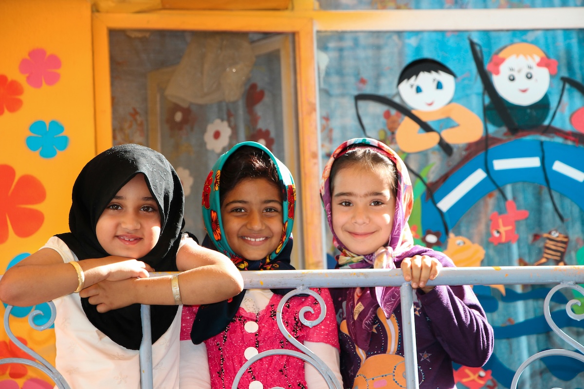 three Muslim girls smiling 