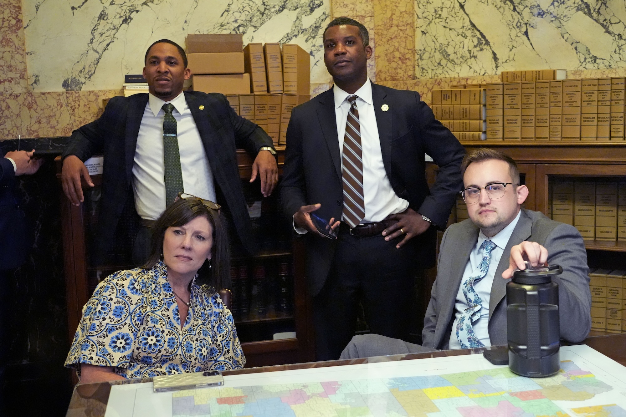 three men in suits and one woman watching from the senate floor