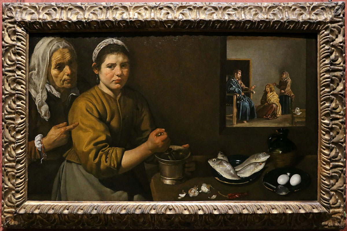 A framed painting that depicts a woman using a mortar and pestle as an older person looks on. In the background can be seen three figures in conversation