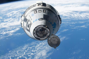 A conical vehicle is seen in space, with earth in the background