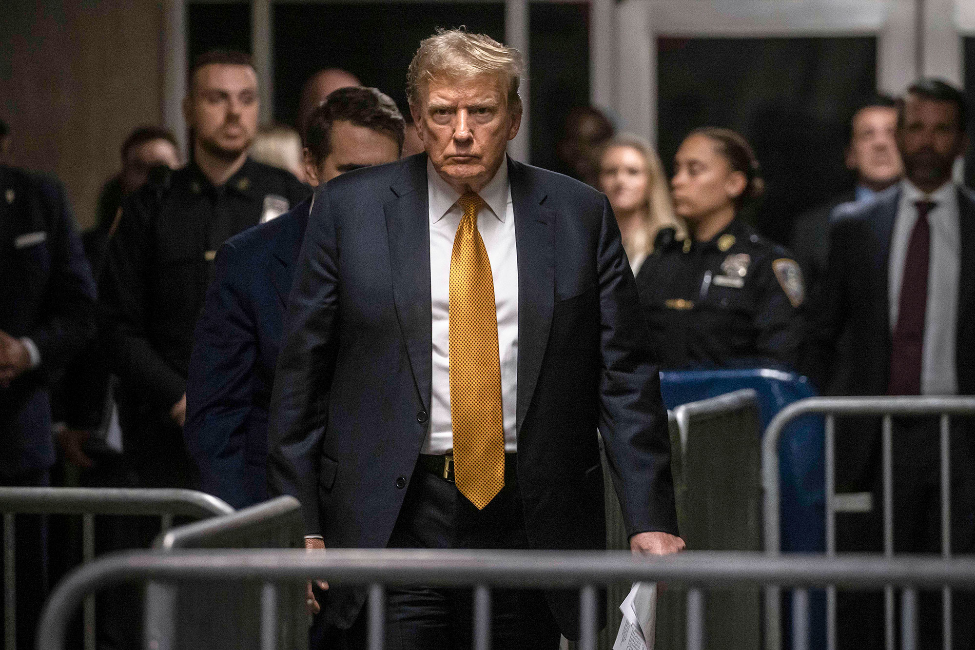 Donald Trump seen walking through a maze of barricades in a courthouse