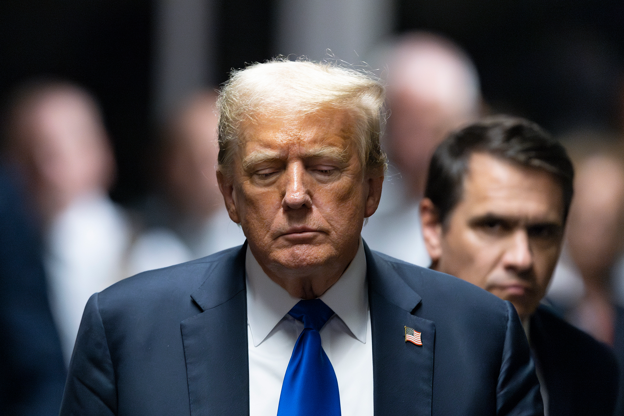 Former President Donald Trump leaves the courthouse with eyes downcast
