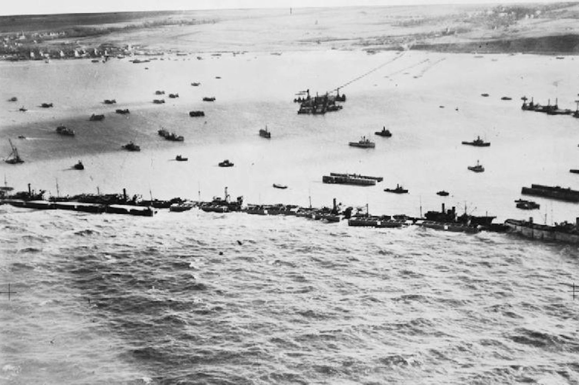 An overhead view of a harbor barricaded with ships
