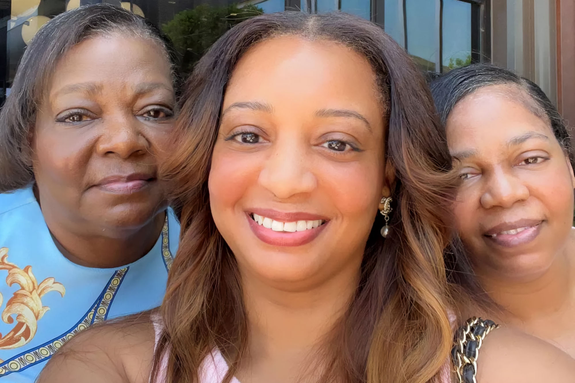 A closeup of three women smiling for a selfie