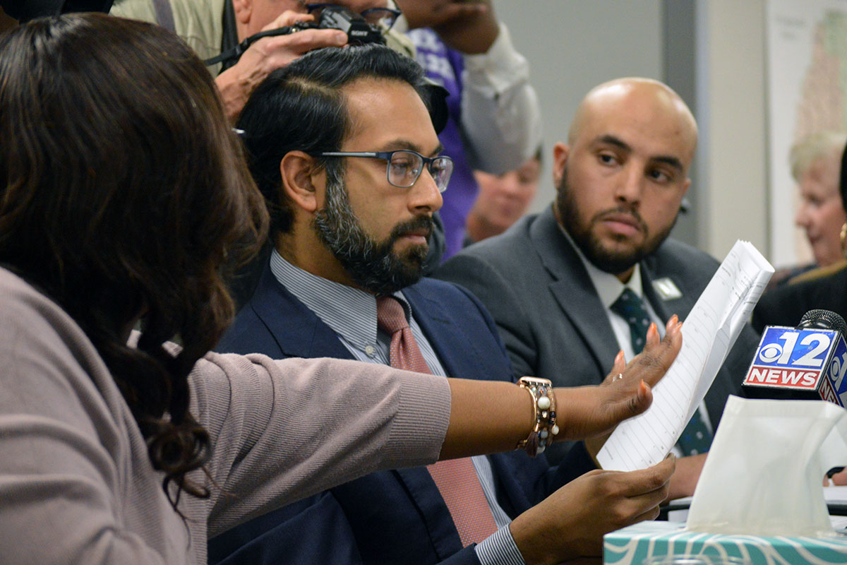 McGee showing ballot reports to voting rights attorney Amir Badat