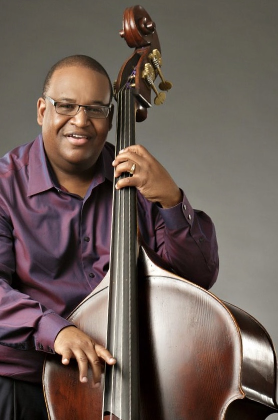 A man with his hands on the strings of a cello