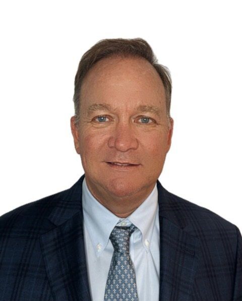 Official headshot of a man in a suit