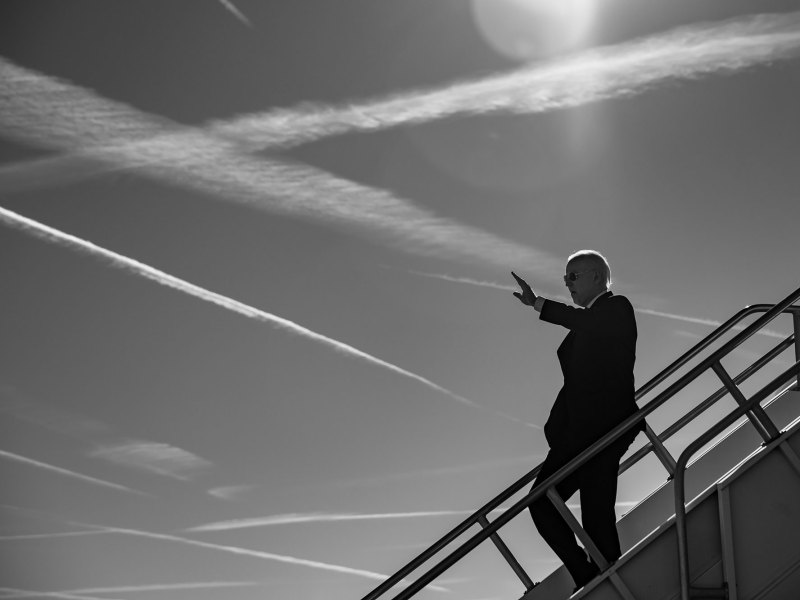 A black and white photo Joe Biden disembarking Air Force One and waving