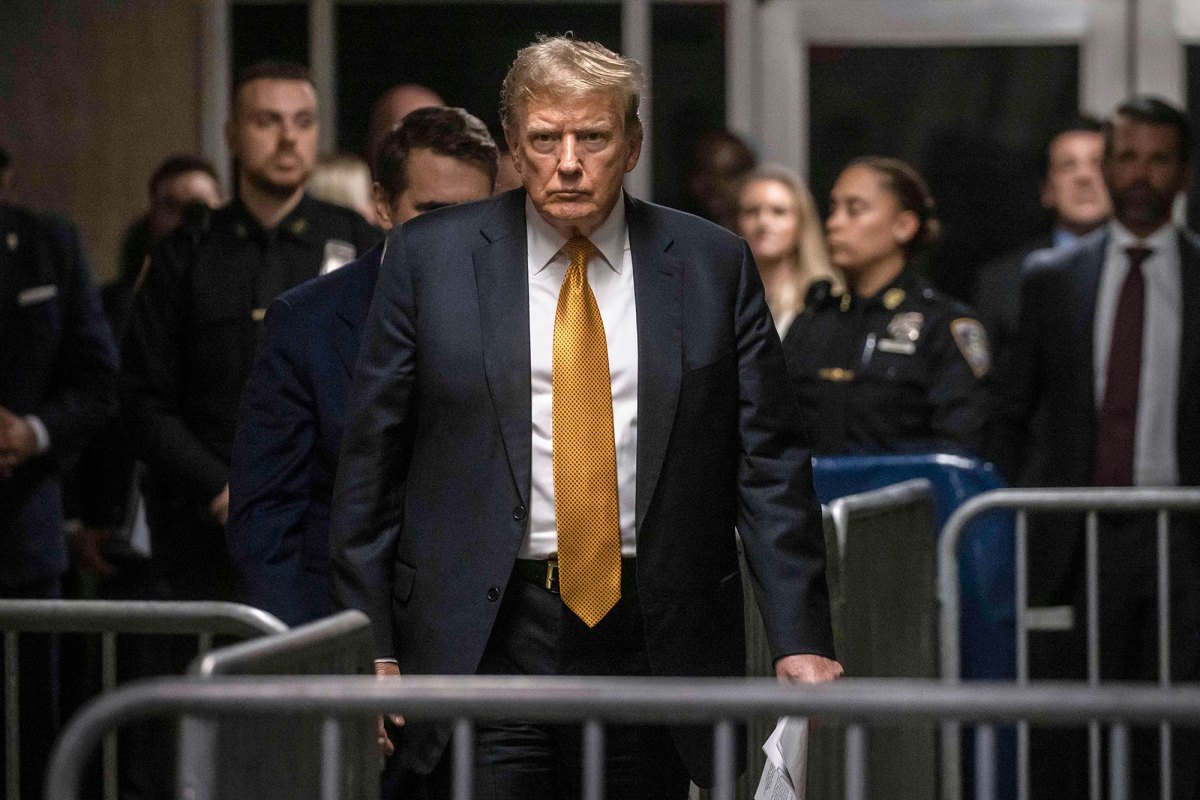 Donald Trump seen walking through a maze of barricades in a courthouse