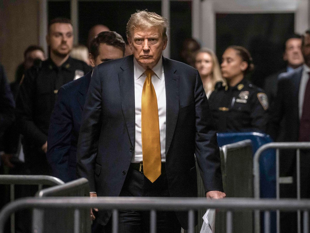 Donald Trump seen walking through a maze of barricades in a courthouse