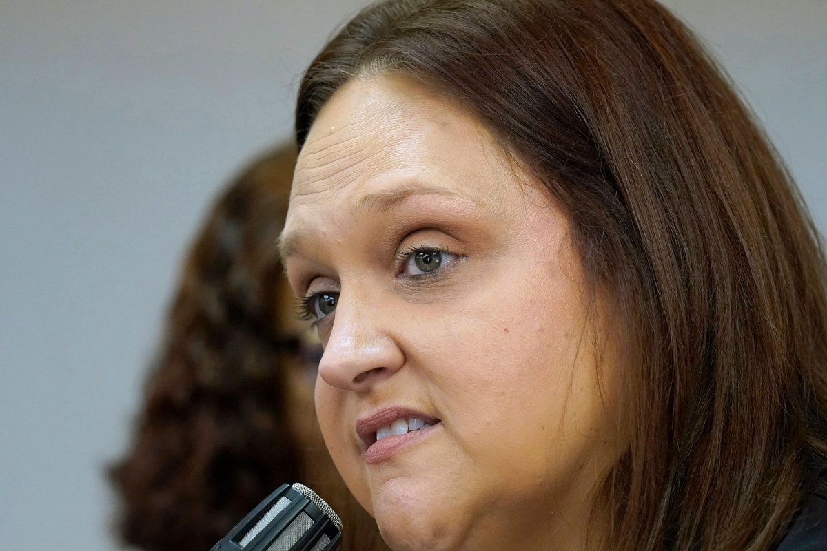 A very close up shot of a woman speaking into a microphone