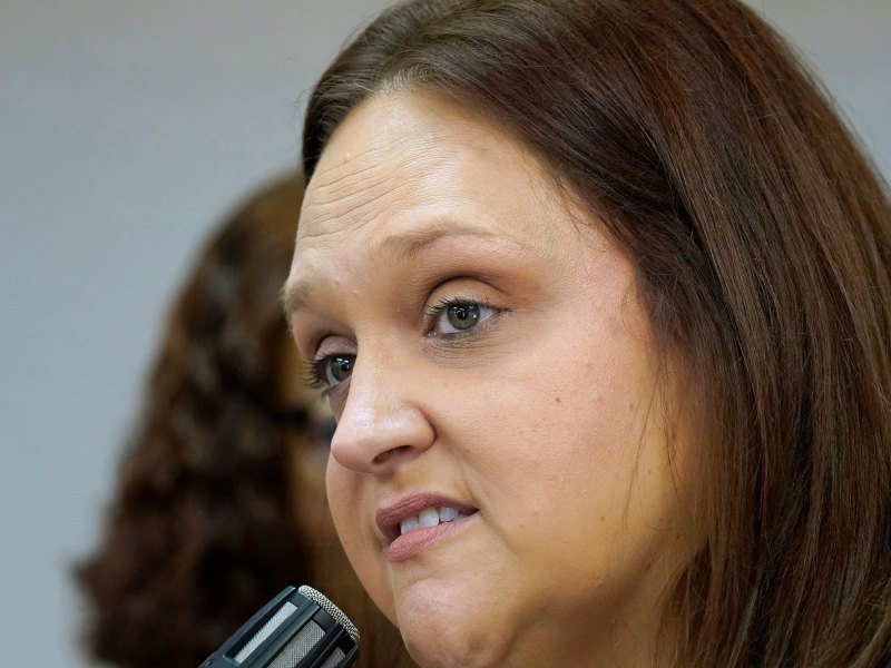 A very close up shot of a woman speaking into a microphone