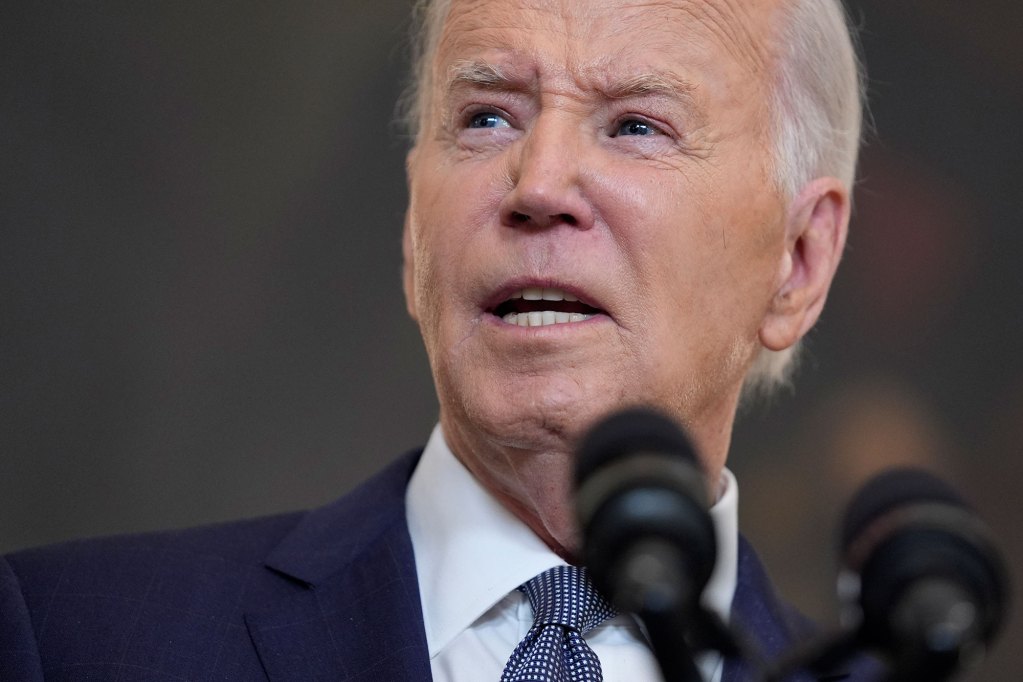 A closeup of President Joe Biden speaking in front of a mic