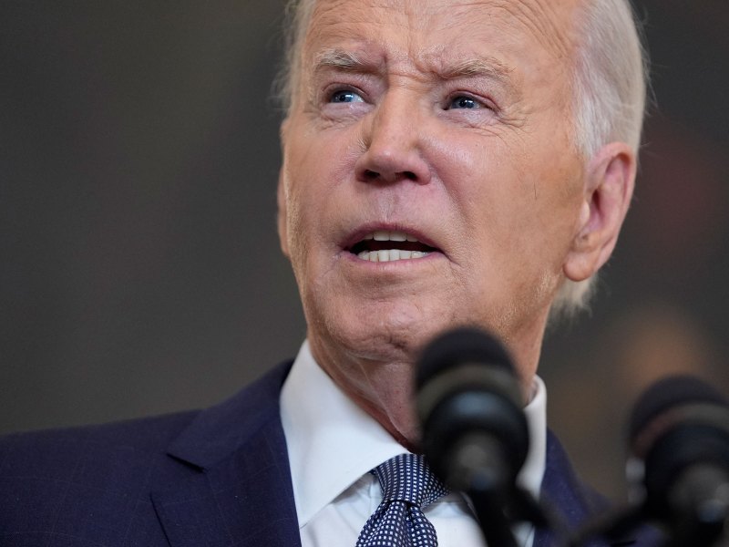 A closeup of President Joe Biden speaking in front of a mic