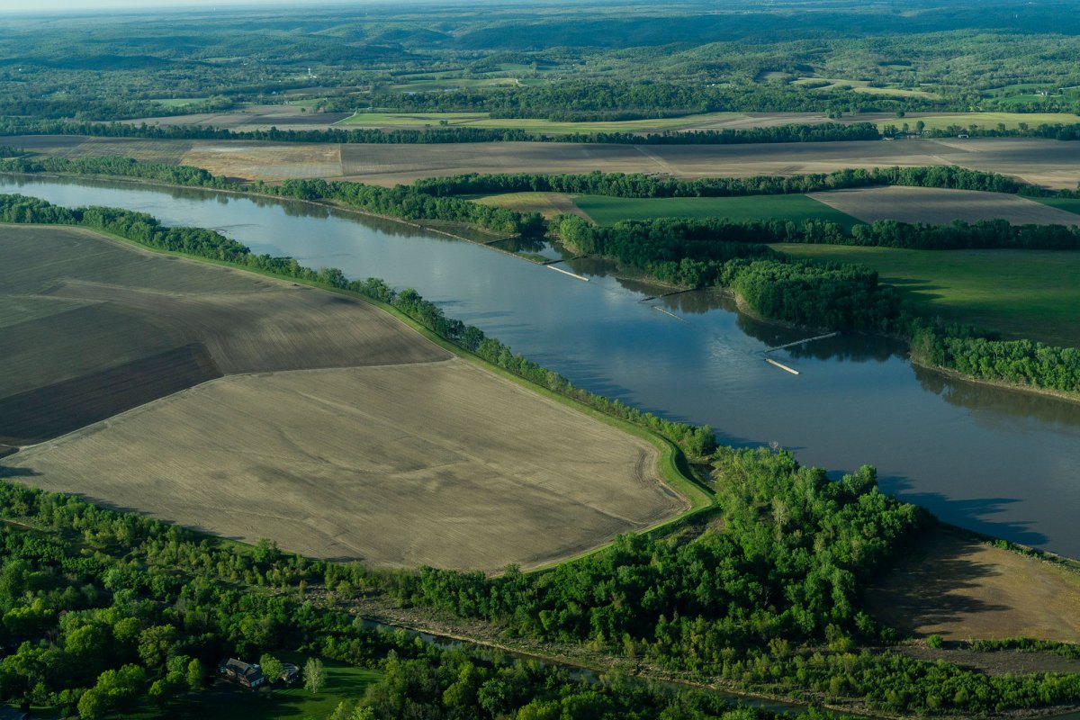 A river runs through a green farm area