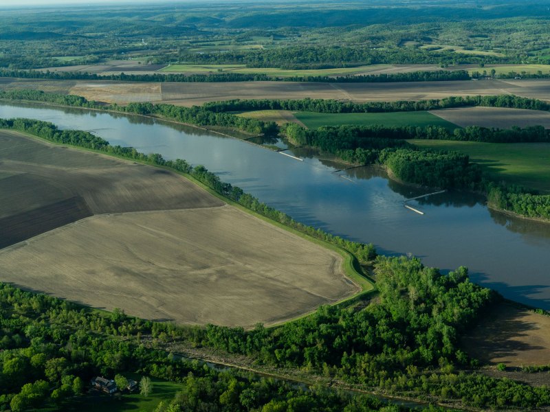 A river runs through a green farm area